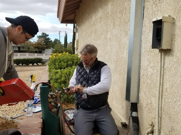 Tri-City Air team working on a home's air conditioning system